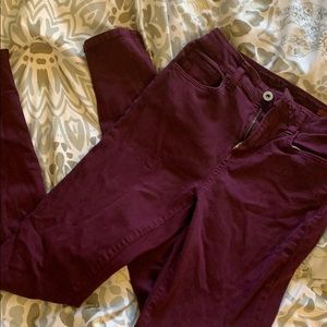 Maroon jeans.